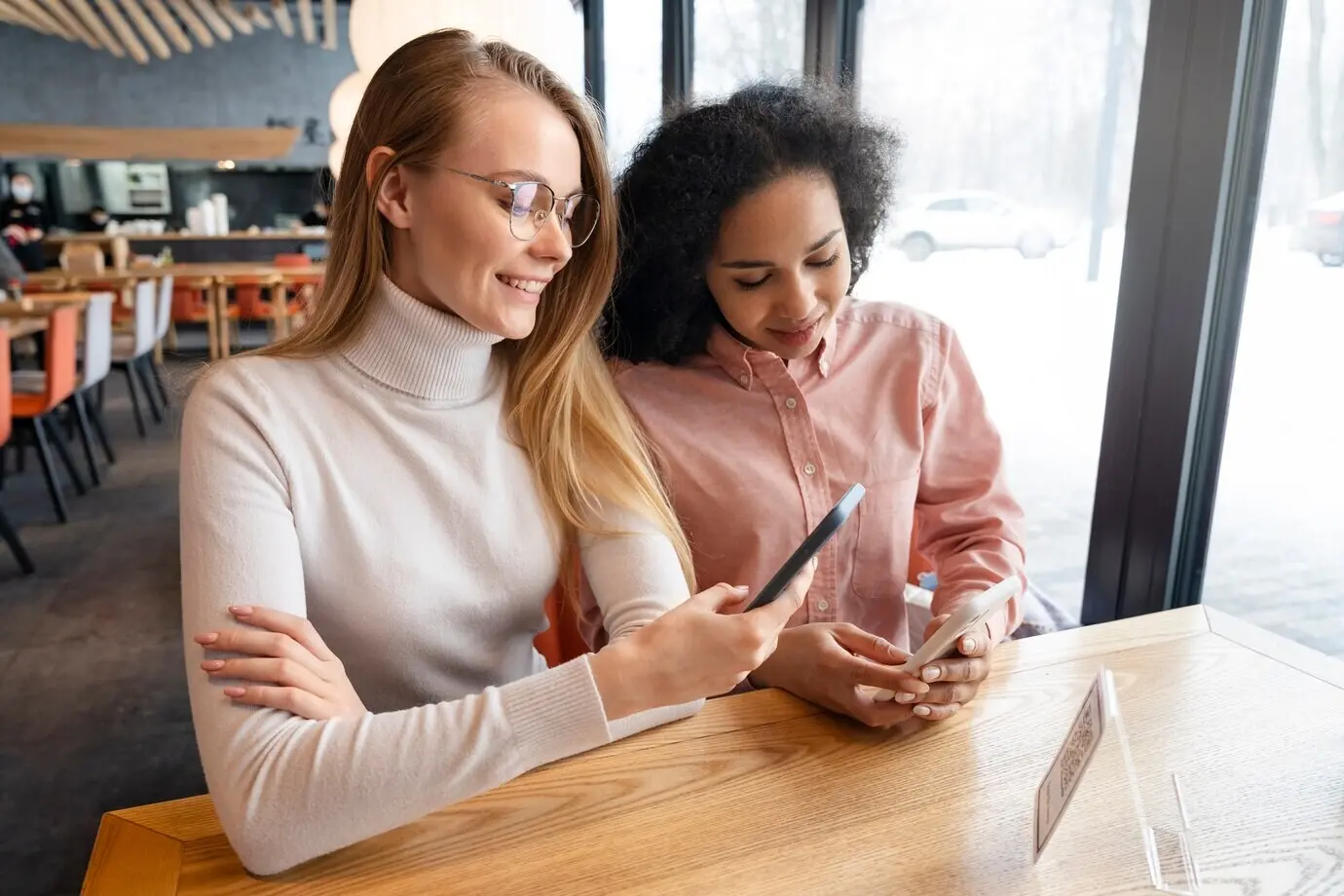 A medium shot of friends scanning a QR menu.