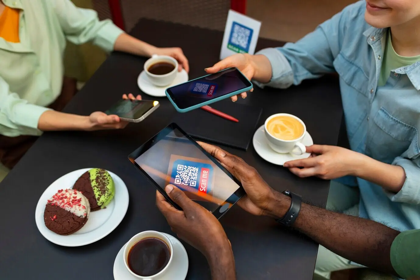 Friends reading a menu in a restaurant, viewed from a high angle.